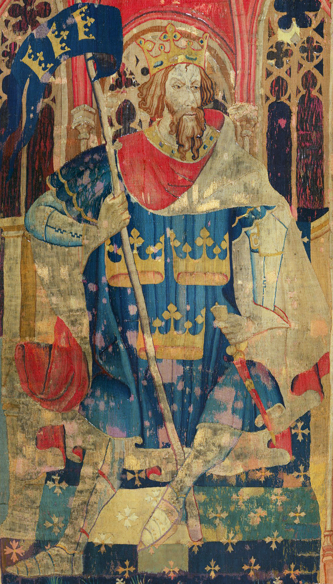 a tapestry depicting King Arthur in blue with a red background