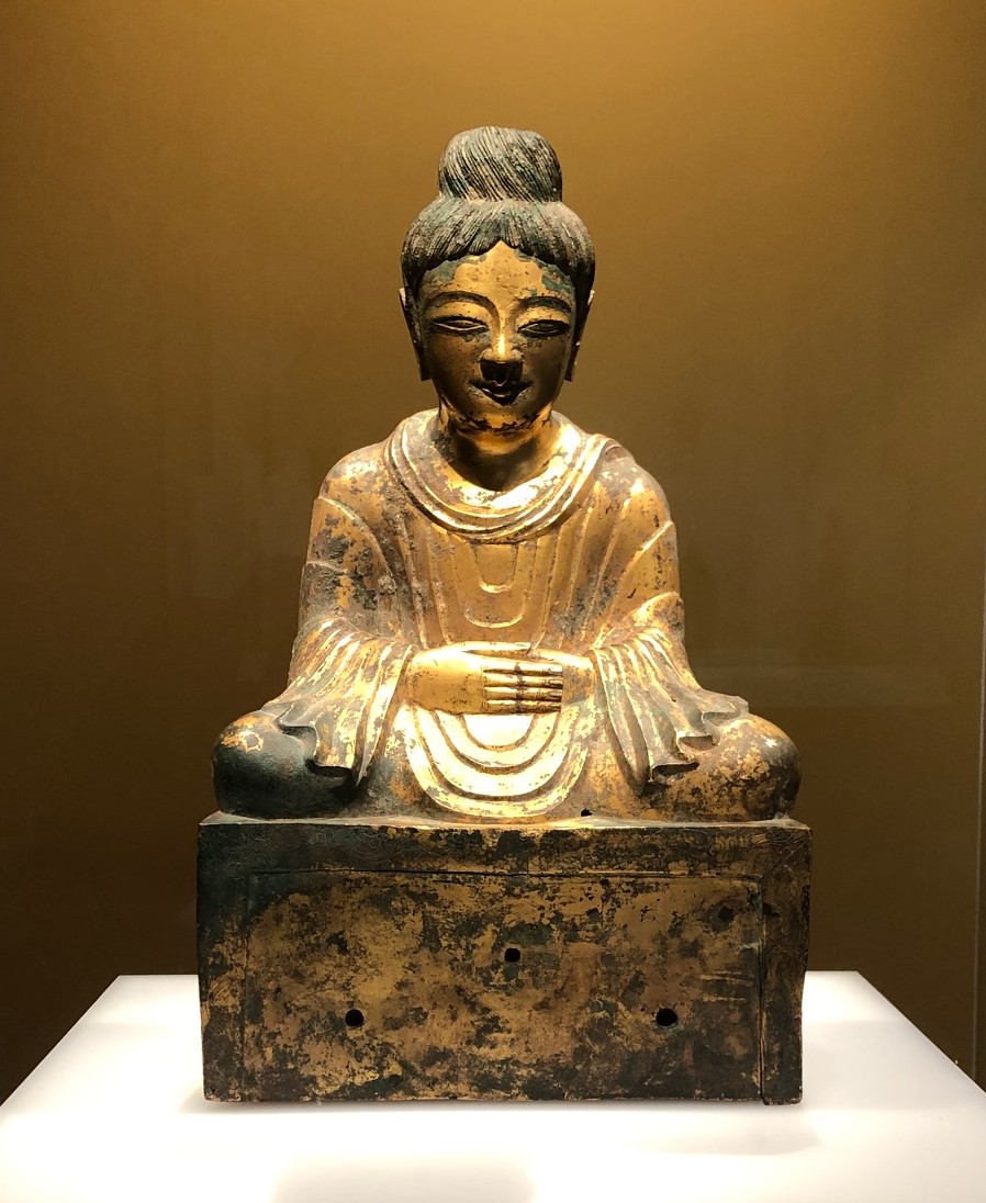 a golden Buddha statue in meditation