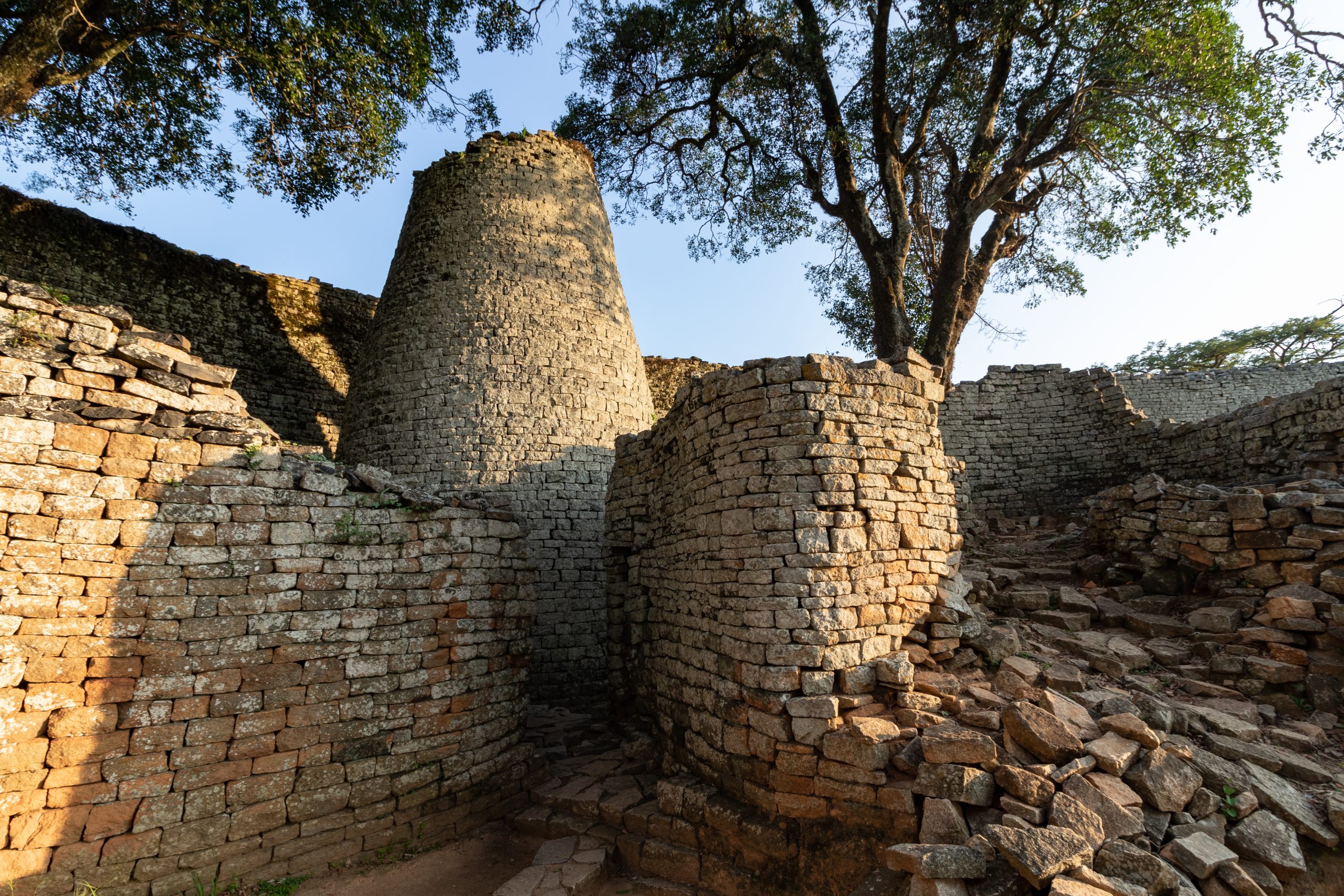 a conical stone tower with a smaller tower in the foreground.