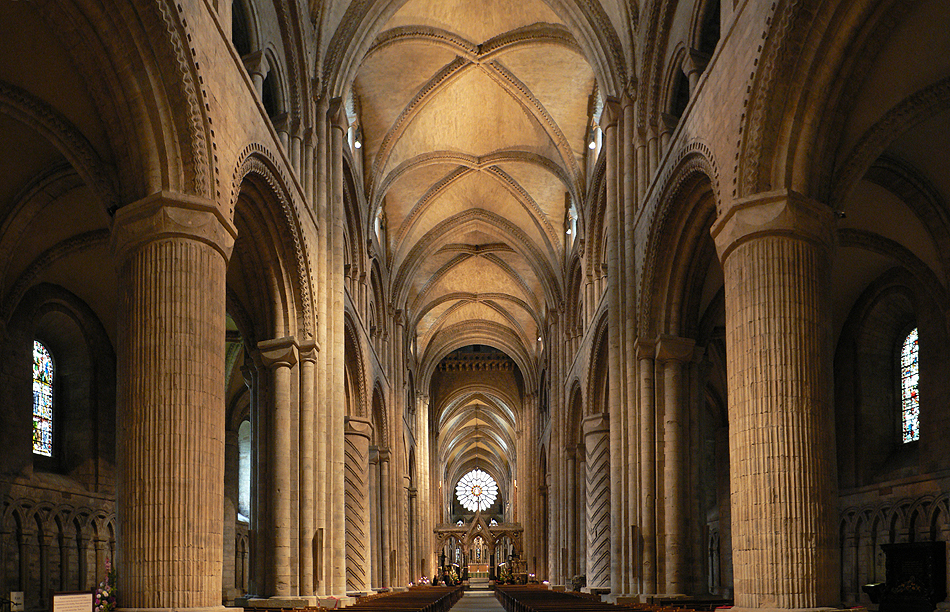interior nave of a Durham cathedral with rose window and arches
