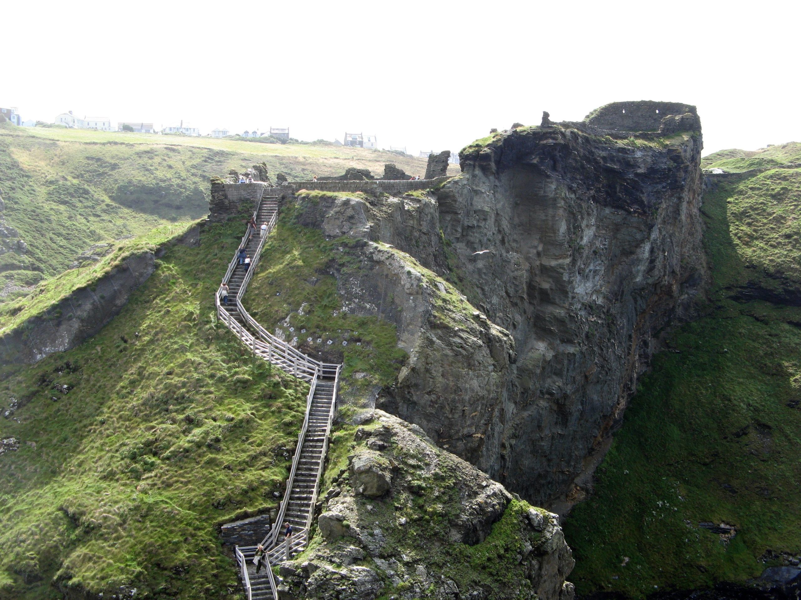 ruins of a castle on a green hill in England