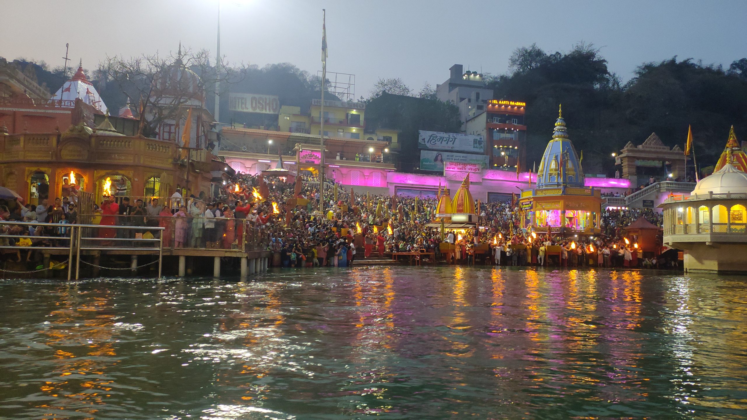 A river with pilgrims carrying lights