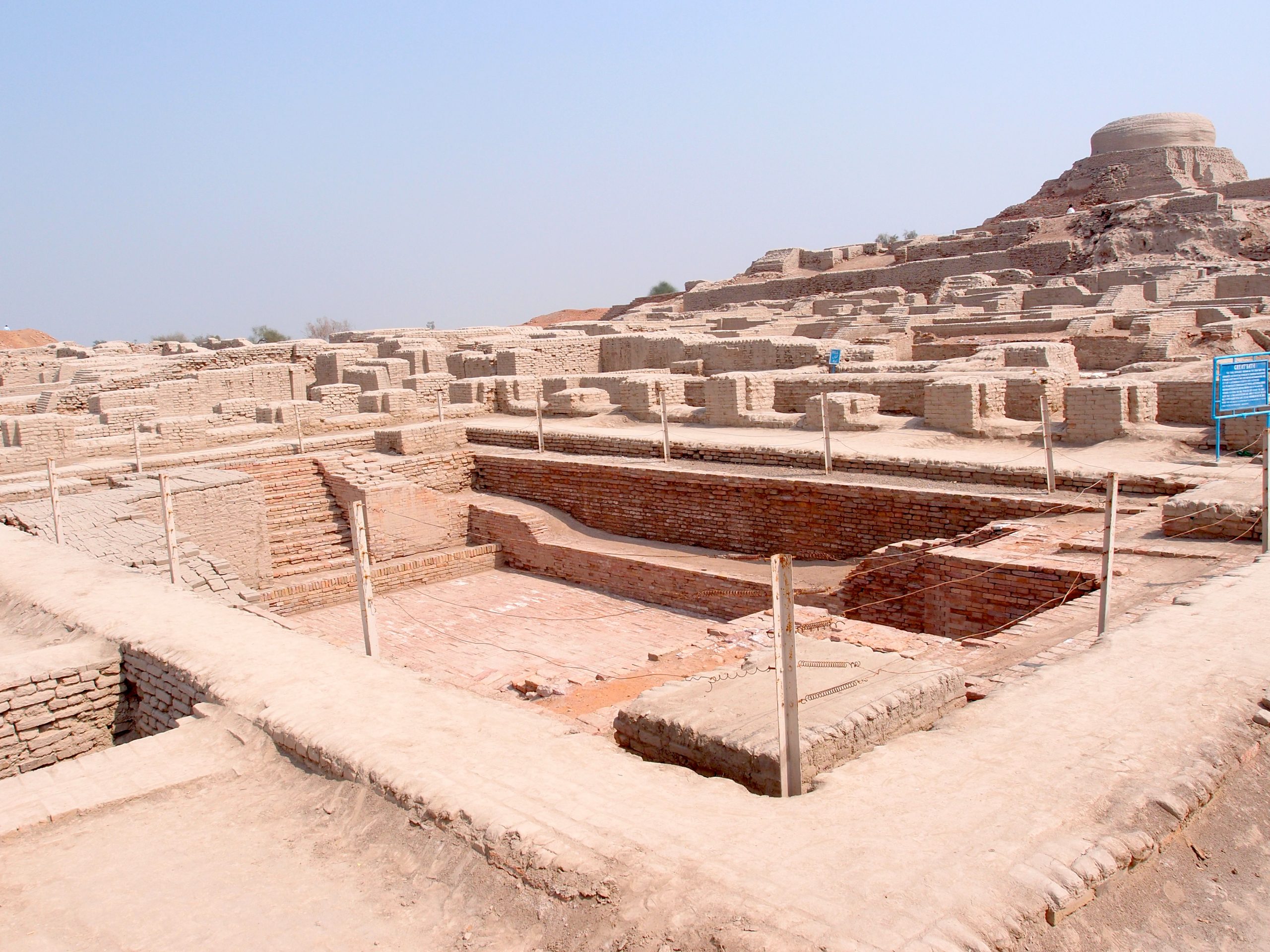 an excavated Indian archaelogical site with ancient baths in the foreground