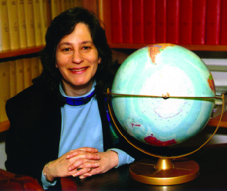 A photograph is shown of Susan Solomon sitting next to a globe.