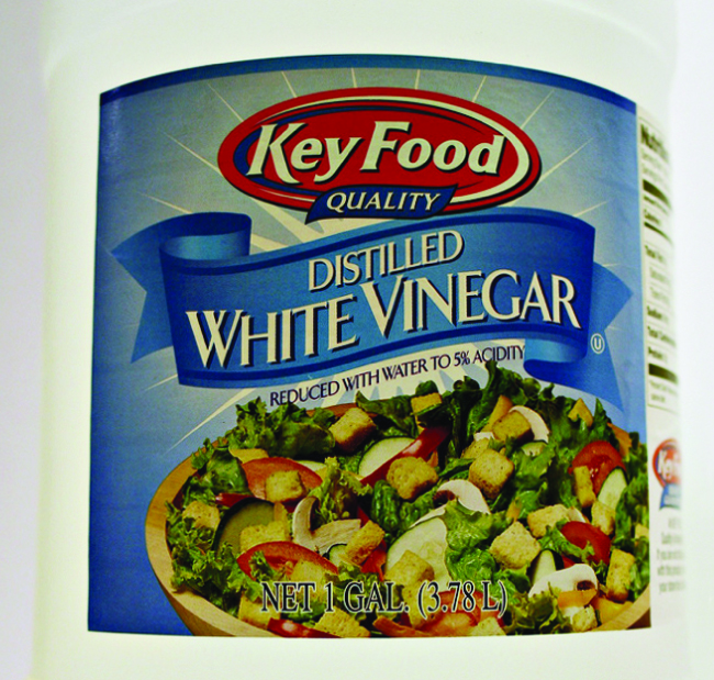 An image shows the label of a bottle of distilled white vinegar. The label states that the contents have been reduced with water to 5 percent acidity.